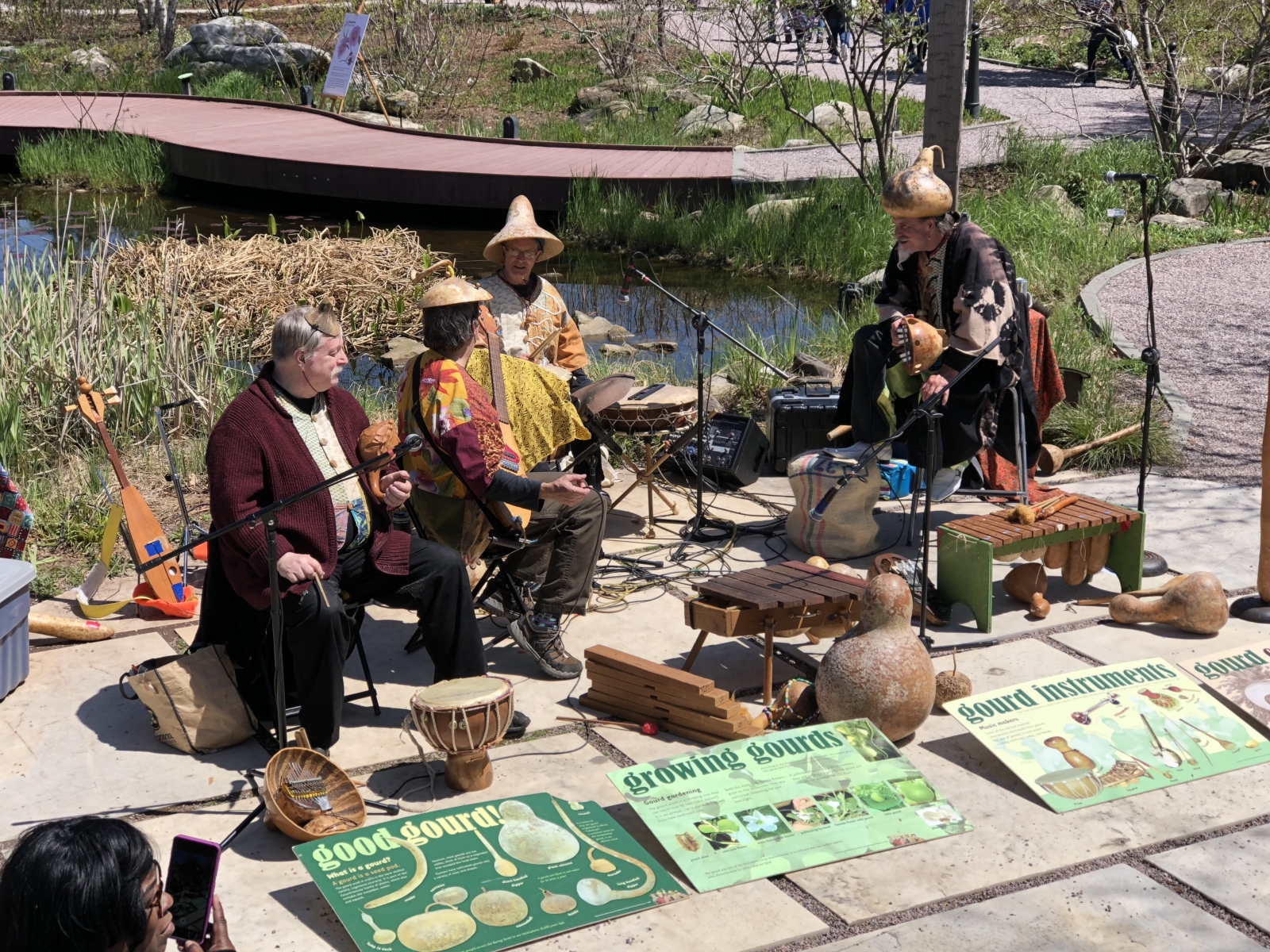Richmond Indigenous Gourd Orchestra plays music on gourds in an outdoor concert in the National Garden