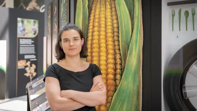 Theresa Dahlman stands with a large photo of corn