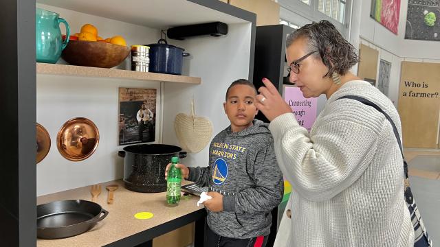 Visitors smell foods in a cooking display of Cultivate exhibit