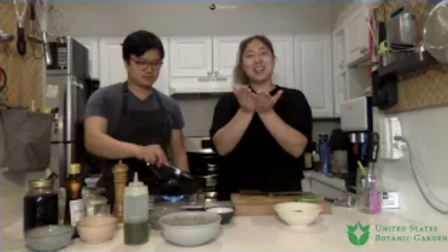 A man and woman cook in a kitchen