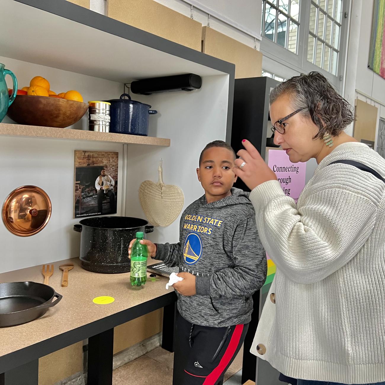 Visitors smell foods in a cooking display of Cultivate exhibit