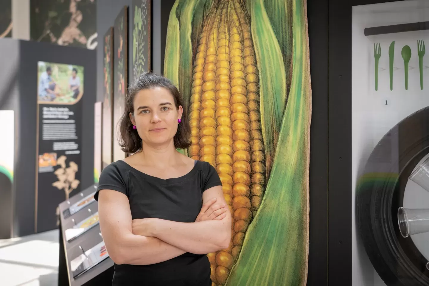 Theresa Dahlman stands with a large photo of corn