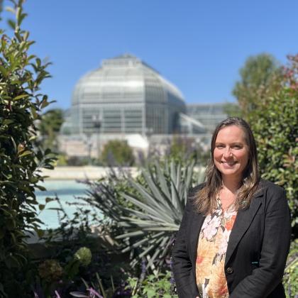 Megan Haidet stands in front of a large Conservatory